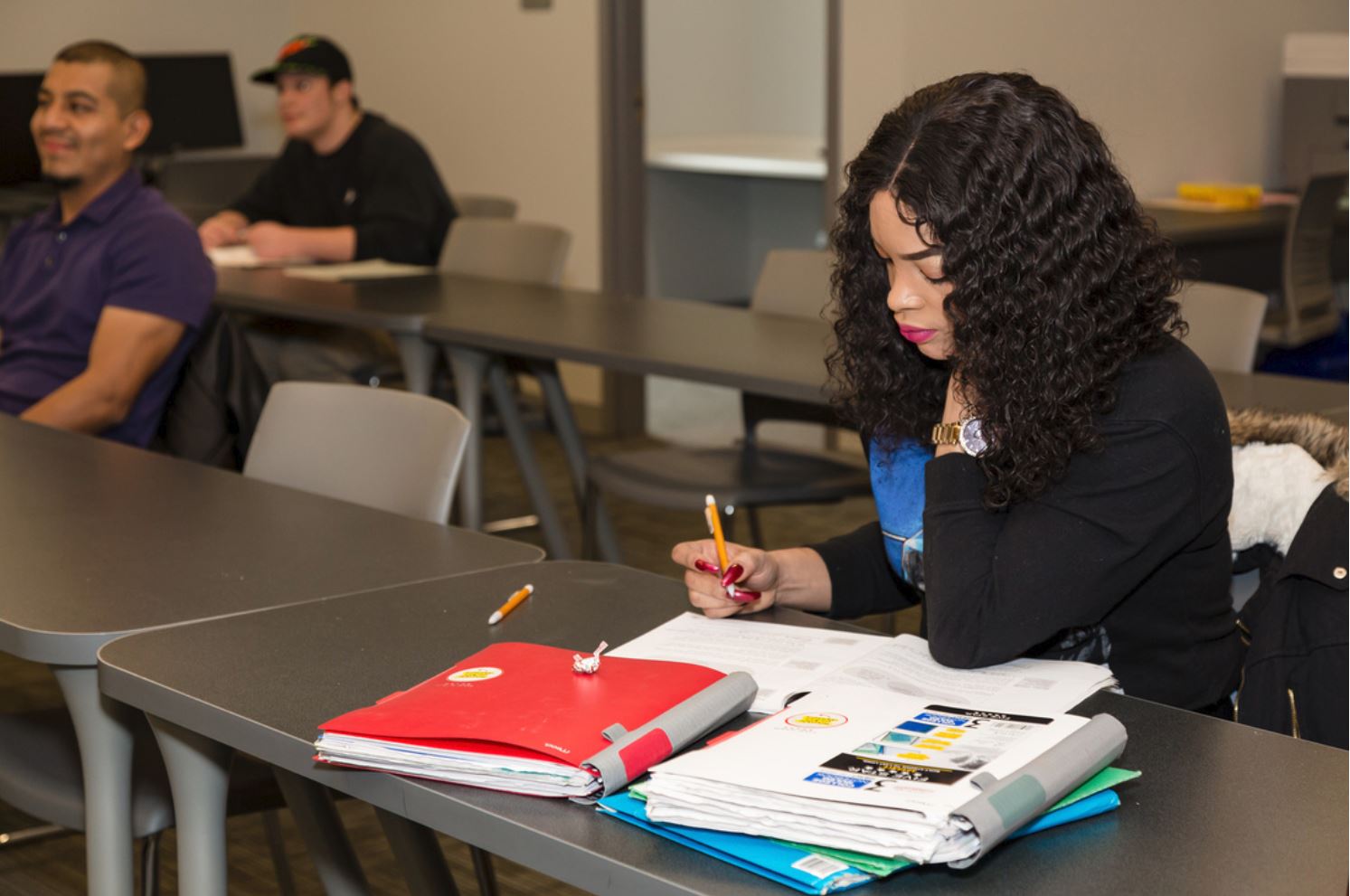 Student taking notes in a continuing education classroom.