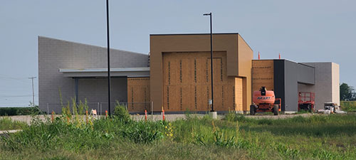 North view of the construction site highlighting the building's main entrance as work progresses
