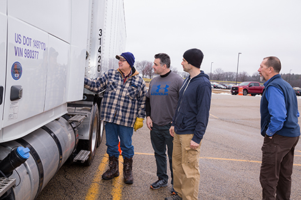 Students and teacher around Semi Truck