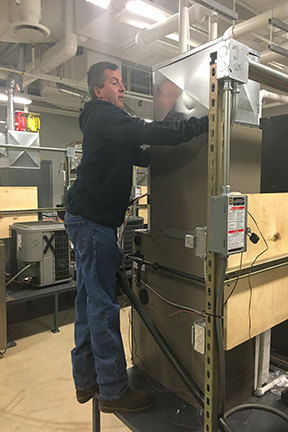 Student working on a ventilation system