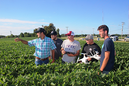 students and instructor working in the field