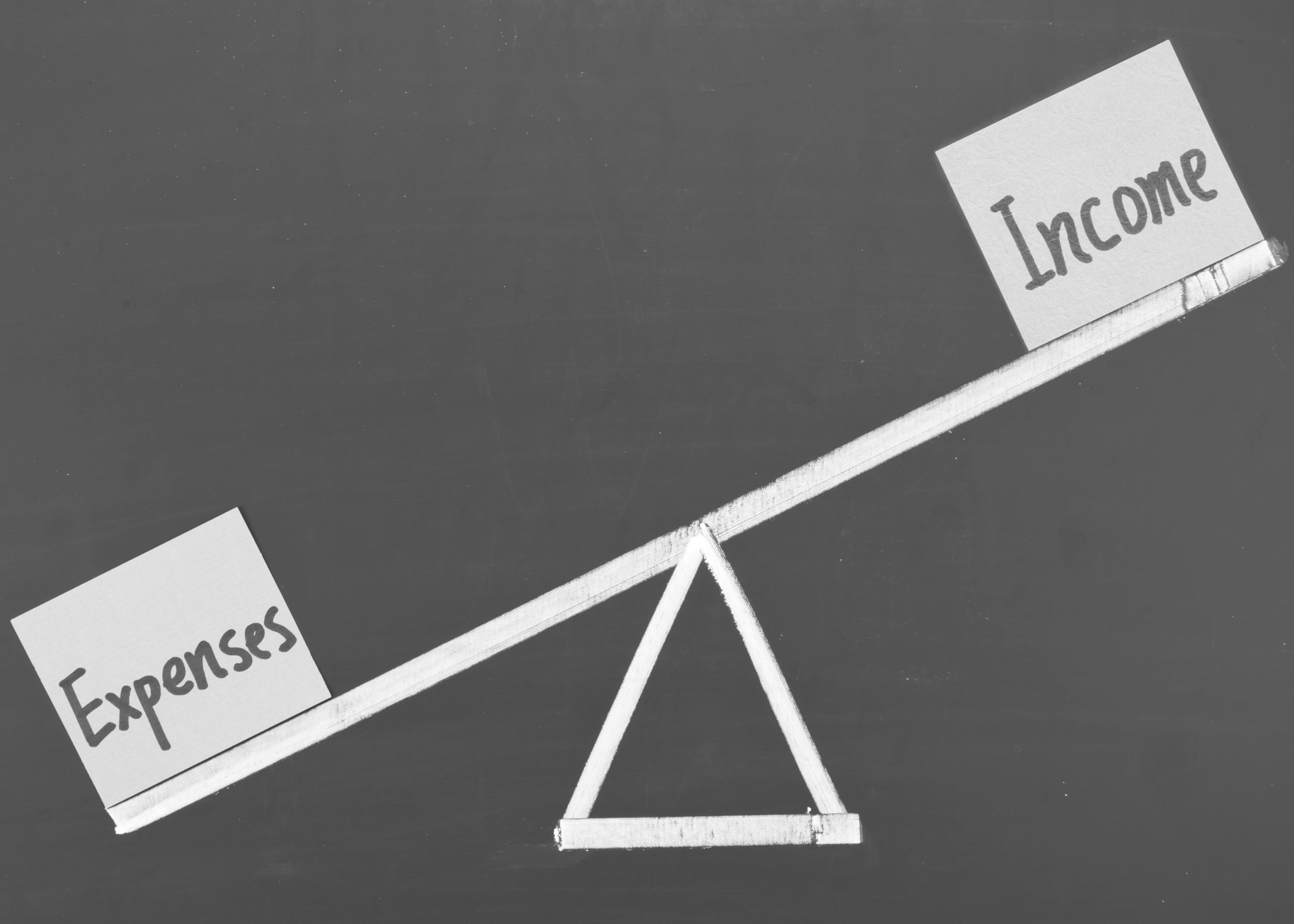 Low income: Seesaw showing expenses weighing more than income