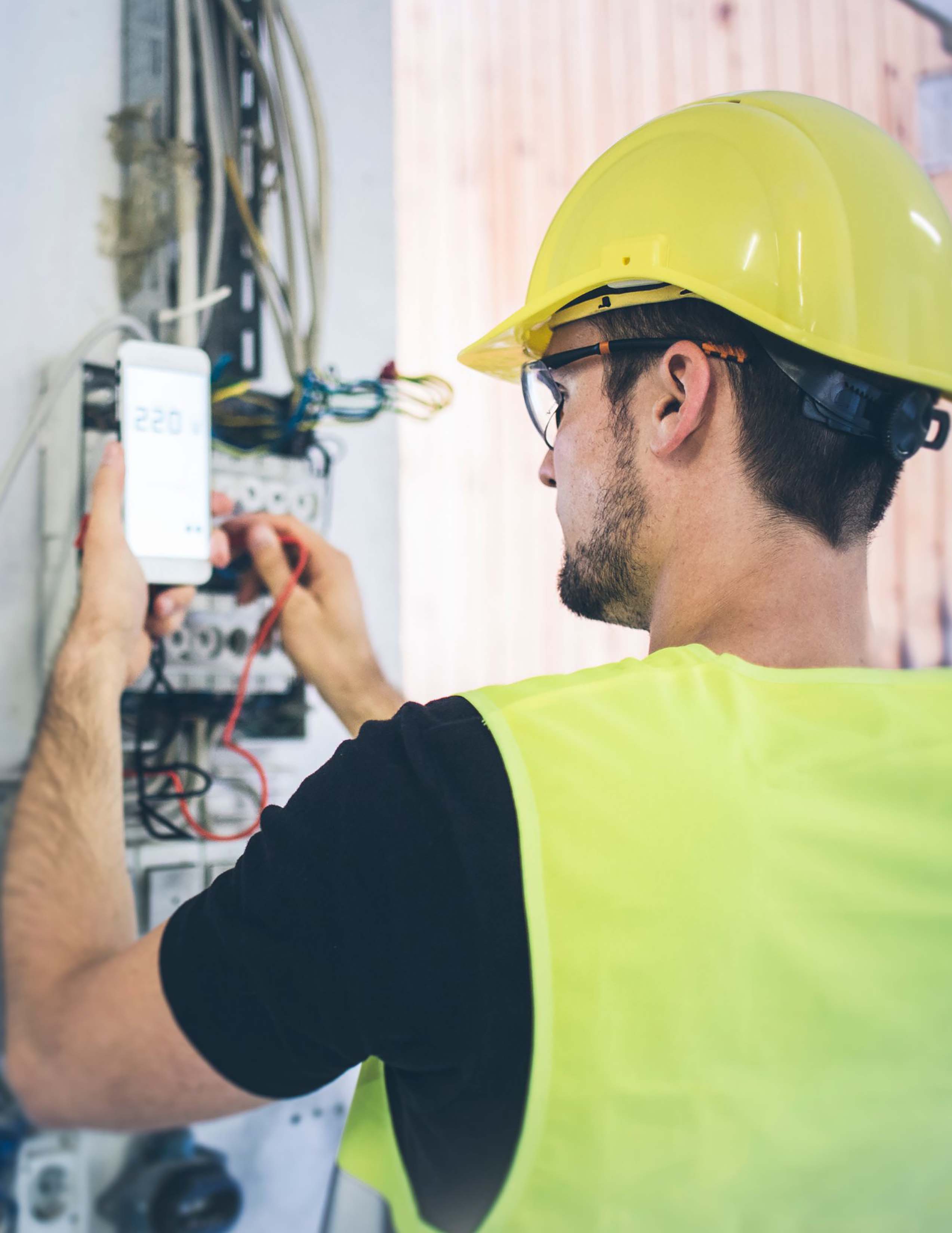 Individual working on electrical panel