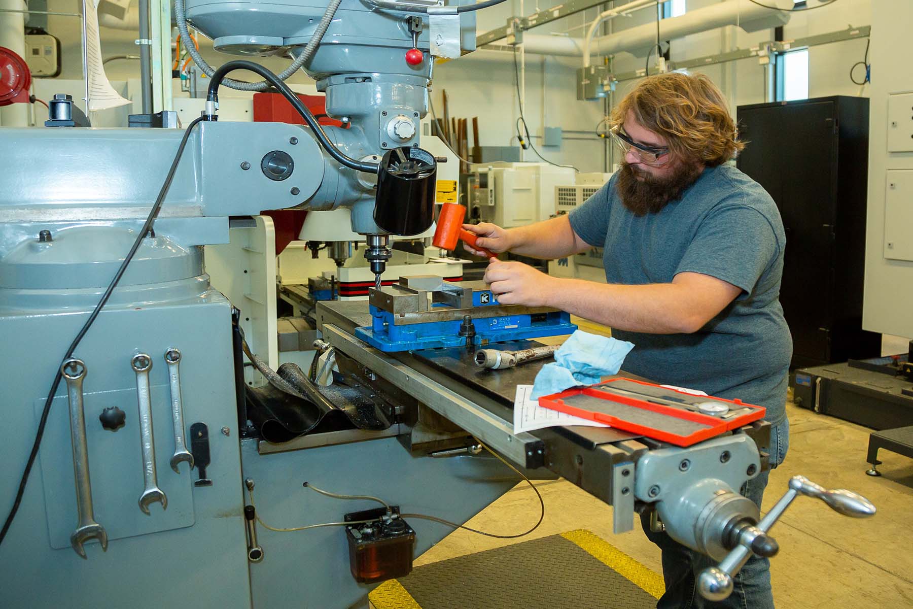 Student working at a manual lathe