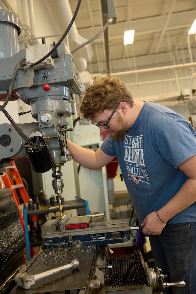 Student working at a manual lathe